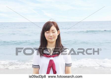 Young woman on beach with eyes closed View Large Photo Image Stock Photo - Young woman on beach with eyes closed. Fotosearch