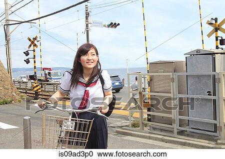 Young woman pushing bicycle View Large Photo Image Stock Image - Young woman pushing bicycle. Fotosearch