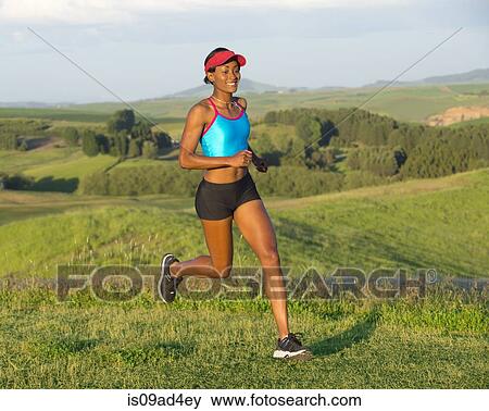 Young woman running in landscape, Othello, Washington, USA View Large Photo Image Stock Photo - Young woman running in landscape, Othello, Washington, USA. Fotosearch