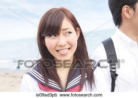 Stock Image - Young woman with tongue out. Fotosearch