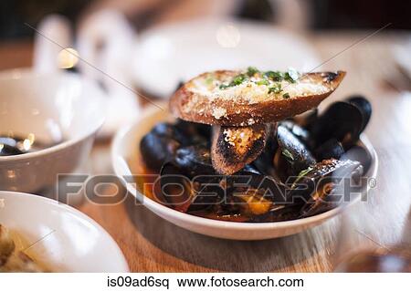 Bowl of mussels with garlic bread View Large Photo Image Stock Photography - Bowl of mussels with garlic bread. Fotosearch