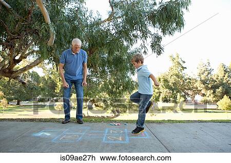 Boy on hopscotch, grandfather watching View Large Photo Image Stock Image - Boy on hopscotch, grandfather watching. Fotosearch