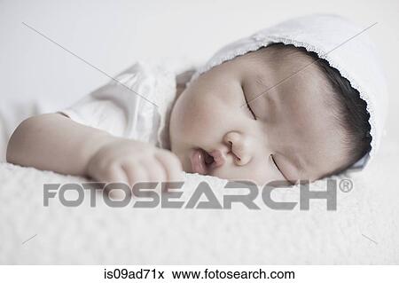 Stock Photo - Close up of baby girl sleeping. Fotosearch
