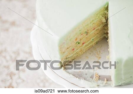 Stock Image - Close up still life of sliced celebration cake. Fotosearch