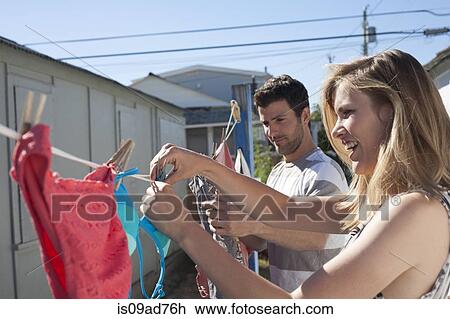 Couple hanging out washing, Breezy Point, Queens, New York, USA View Large Photo Image Stock Image - Couple hanging out washing, Breezy Point, Queens, New York, USA. Fotosearch
