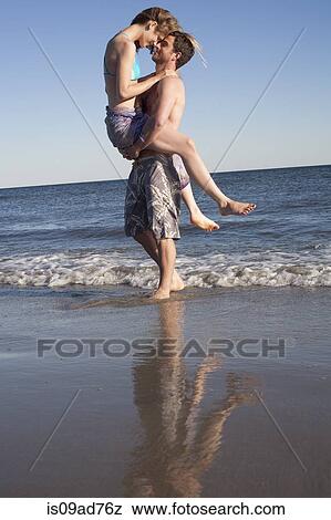 Stock Photo - Couple having fun on beach, Breezy Point, Queens, New York, USA. Fotosearch