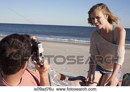 Couple photographing on beach, Breezy Point, Queens, New York, USA View Large Photo Image Stock Photograph - Couple photographing on beach, Breezy Point, Queens, New York, USA. Fotosearch