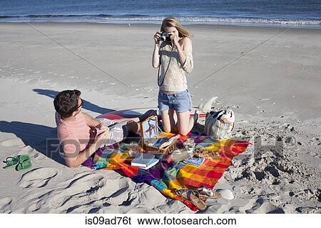 Couple picnicing and photographing, Breezy Point, Queens, New York, USA View Large Photo Image Stock Photograph - Couple picnicing and photographing, Breezy Point, Queens, New York, USA. Fotosearch