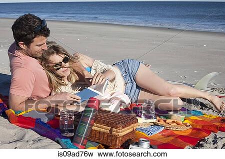 Couple sharing picnic on beach, Breezy Point, Queens, New York, USA View Large Photo Image Stock Photo - Couple sharing picnic on beach, Breezy Point, Queens, New York, USA. Fotosearch