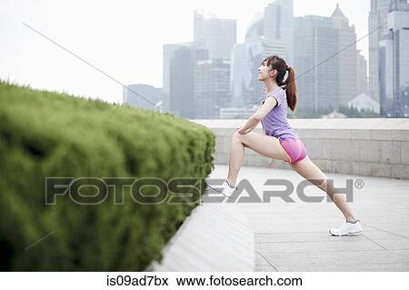 Female jogger stretching in Shanghai, China View Large Photo Image Stock Photo - Female jogger stretching in Shanghai, China. Fotosearch