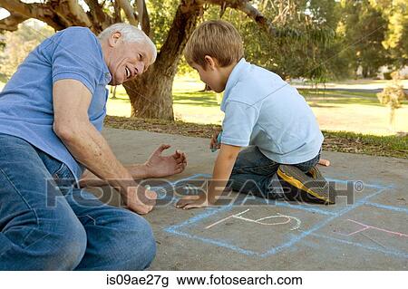 Grandfather and grandson drawing hopscotch View Large Photo Image Stock Image - Grandfather and grandson drawing hopscotch. Fotosearch