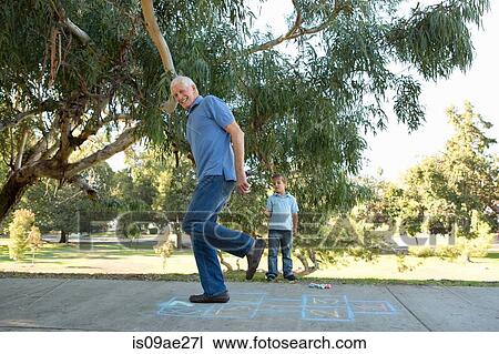 Grandfather on hopscotch, boy watching View Large Photo Image Stock Image - Grandfather on hopscotch, boy watching. Fotosearch