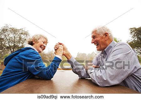 Husband and wife arm wrestling in the park View Large Photo Image Stock Image - Husband and wife arm wrestling in the park. Fotosearch