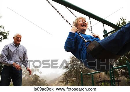 Husband pushing wife on swing View Large Photo Image Stock Image - Husband pushing wife on swing. Fotosearch