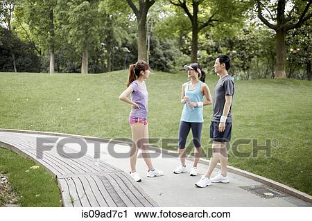 Stock Image - Joggers on path in park. Fotosearch