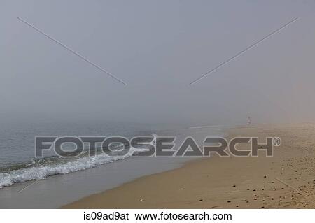 Person strolling on misty beach, Poole, Dorset, UK View Large Photo Image Stock Photograph - Person strolling on misty beach, Poole, Dorset, UK. Fotosearch