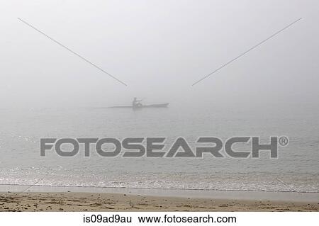 Sea kayaker on misty sea, Poole, Dorset, UK View Large Photo Image Stock Photograph - Sea kayaker on misty sea, Poole, Dorset, UK. Fotosearch
