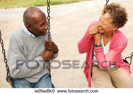 Senior couple on swings in park View Large Photo Image Stock Image - Senior couple on swings in park. Fotosearch