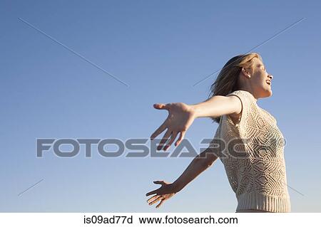 Stock Image - Smiling woman enjoying beach, Breezy Point, Queens, New York, USA. Fotosearch