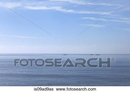 Three sea kayakers on horizon, Poole, Dorset, UK View Large Photo Image Stock Photograph - Three sea kayakers on horizon, Poole, Dorset, UK. Fotosearch