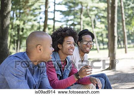 Three young men in park View Large Photo Image Picture - Three young men in park. Fotosearch