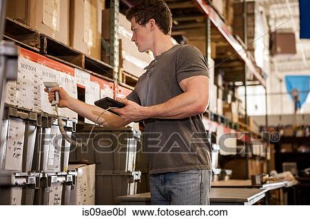Worker in warehouse scanning barcode on cardboard box View Large Photo Image Stock Image - Worker in warehouse scanning barcode on cardboard box. Fotosearch