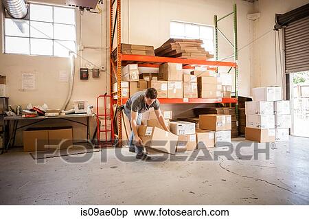 Worker lifting cardboard box View Large Photo Image Stock Photography - Worker lifting cardboard box. Fotosearch