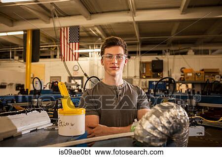 Worker operating machinery in factory View Large Photo Image Stock Photograph - Worker operating machinery in factory. Fotosearch