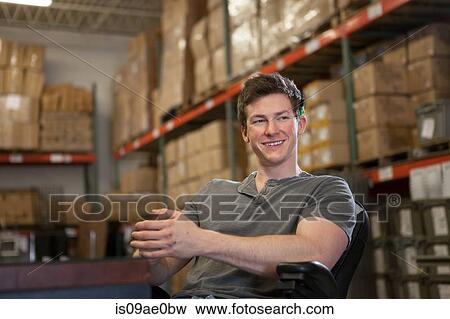 Worker sitting in warehouse View Large Photo Image Stock Photo - Worker sitting in warehouse. Fotosearch