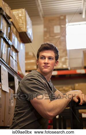 Worker standing in warehouse View Large Photo Image Stock Photo - Worker standing in warehouse. Fotosearch