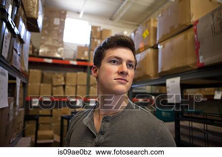 Worker standing in warehouse View Large Photo Image Stock Photo - Worker standing in warehouse. Fotosearch