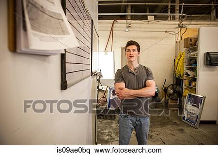 Worker standing in warehouse View Large Photo Image Stock Photography - Worker standing in warehouse. Fotosearch