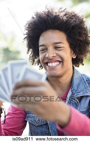 Young man playing cards View Large Photo Image Stock Image - Young man playing cards. Fotosearch