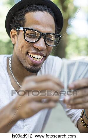 Young man playing cards View Large Photo Image Stock Image - Young man playing cards. Fotosearch