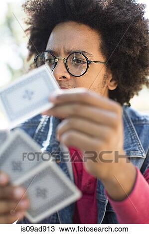 Stock Image - Young man playing cards. Fotosearch