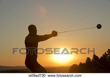 Young man preparing to throw the hammer at sunset View Large Photo Image Stock Image - Young man preparing to throw the hammer at sunset. Fotosearch