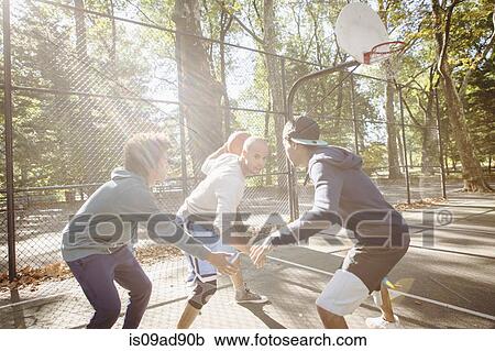 Young men playing basketball View Large Photo Image Stock Image - Young men playing basketball. Fotosearch