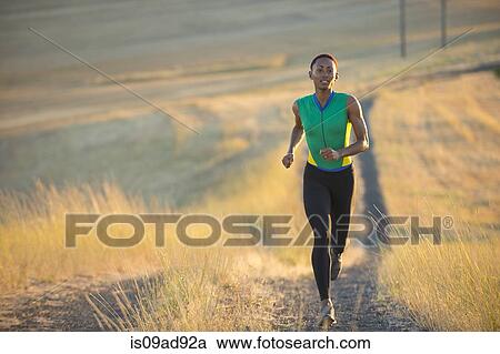 Young woman running on dirt track, Bainbridge Island, Washington State, USA View Large Photo Image Stock Image - Young woman running on dirt track, Bainbridge Island, Washington State, USA. Fotosearch