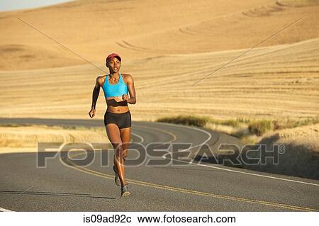 Young woman running on road, Bainbridge Island, Washington State, USA View Large Photo Image Stock Image - Young woman running on road, Bainbridge Island, Washington State, USA. Fotosearch