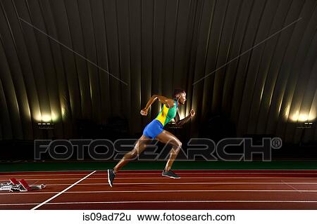 Young woman sprinting in stadium View Large Photo Image Stock Photograph - Young woman sprinting in stadium. Fotosearch