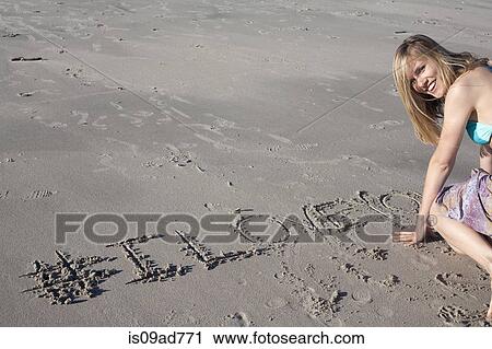 Young woman writing love message in sand, Breezy Point, Queens, New York, USA View Large Photo Image Stock Image - Young woman writing love message in sand, Breezy Point, Queens, New York, USA. Fotosearch