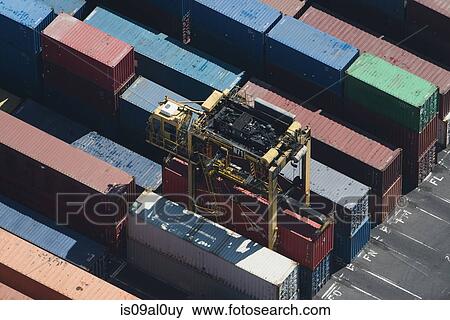 Aerial view of cargo container being retrieved, Port Melbourne, Melbourne, Victoria, Australia View Large Photo Image Stock Photo - Aerial view of cargo container being retrieved, Port Melbourne, Melbourne, Victoria, Australia. Fotosearch