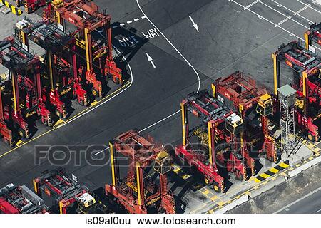 Stock Photograph - Aerial view of cargo container lifting trucks, Port Melbourne, Melbourne, Victoria, Australia. Fotosearch