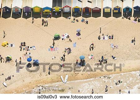 Stock Image - Aerial view of holiday makers and beach huts on Brighton beach, Melbourne, Victoria, Australia. Fotosearch