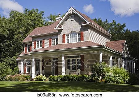 Beige stone with white and red trim residential cottage style house, Quebec, Canada View Large Photo Image Picture - Beige stone with white and red trim residential cottage style house, Quebec, Canada. Fotosearch