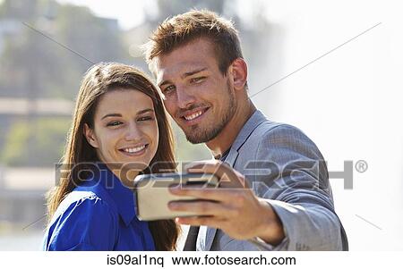 Businessman and woman taking selfie View Large Photo Image Stock Photography - Businessman and woman taking selfie. Fotosearch