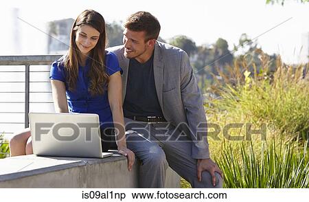 Businessman and woman using laptop, Echo Park, Los Angeles, California, US View Large Photo Image Stock Photography - Businessman and woman using laptop, Echo Park, Los Angeles, California, US. Fotosearch