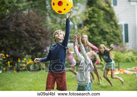 Children playing ball game in garden View Large Photo Image Stock Image - Children playing ball game in garden. Fotosearch