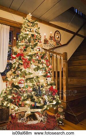 Picture - Christmas tree and lights in the living room of log home. Fotosearch