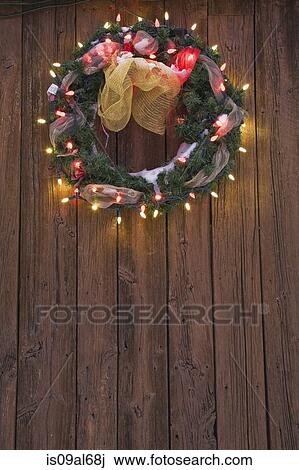 Christmas wreath with christmas lights on wooden door View Large Photo Image Stock Image - Christmas wreath with christmas lights on wooden door. Fotosearch